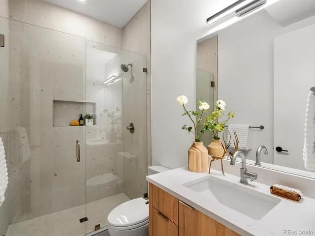 a bathroom with a sink toilet and shower