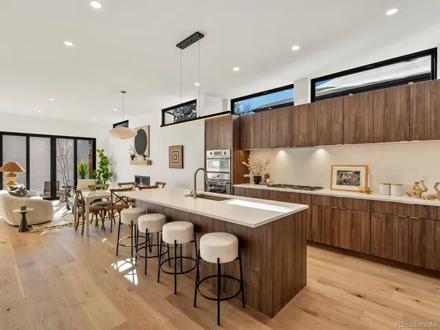 a kitchen with a table chairs stove and cabinets