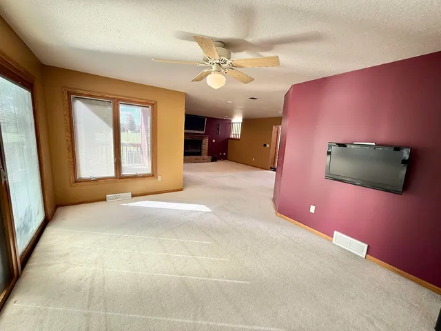 a view of a livingroom with a ceiling fan and window
