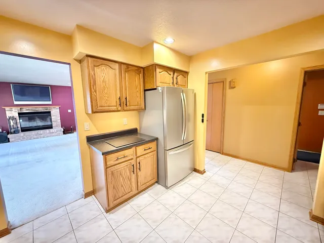 a kitchen with stainless steel appliances granite countertop a refrigerator and a stove