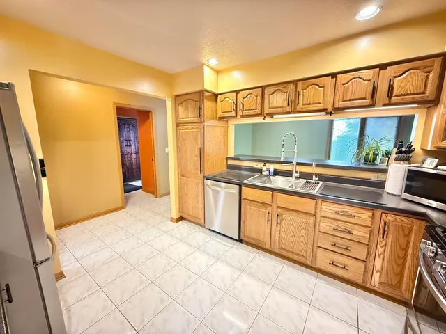 a kitchen with stainless steel appliances granite countertop a sink and cabinets