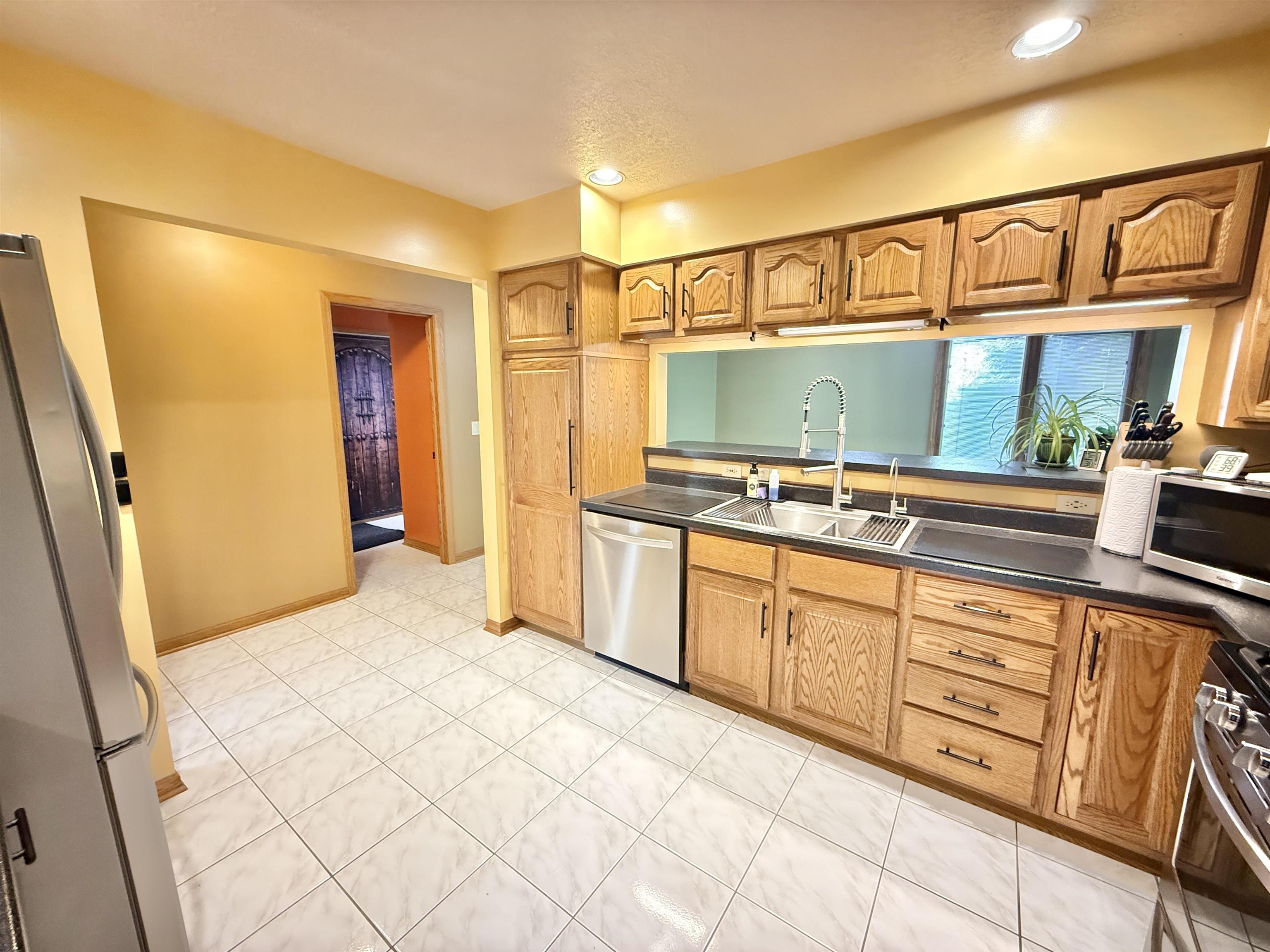 5449 South Branch Court Rochelle, IL 61068 - Photo 15 of 45 a kitchen with stainless steel appliances granite countertop a sink and cabinets