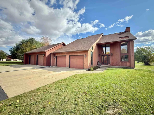 a front view of a house with a garden and yard