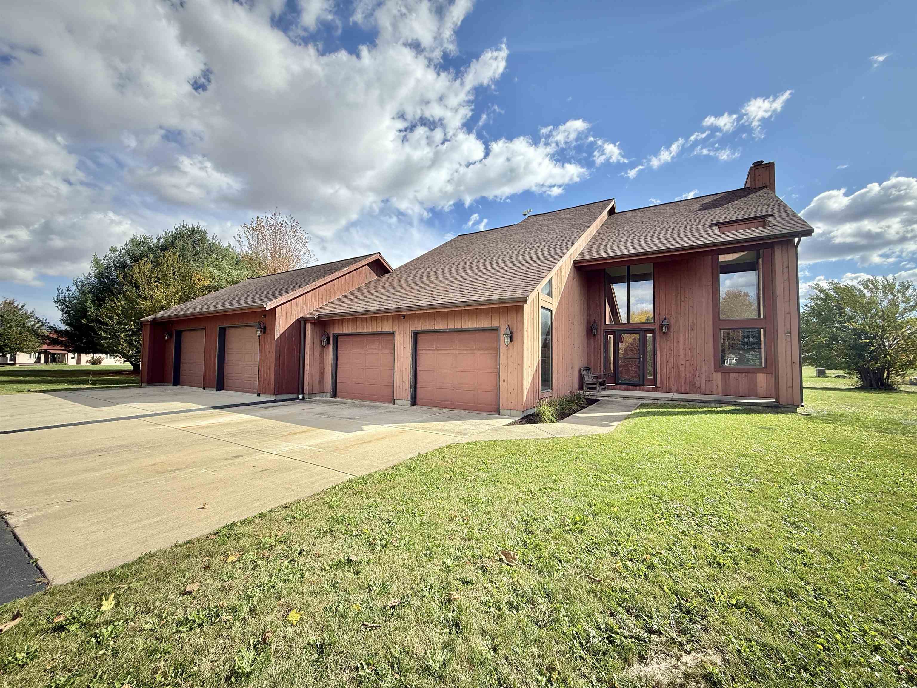 5449 South Branch Court Rochelle, IL 61068 - Photo 2 of 45 a front view of a house with a garden and yard