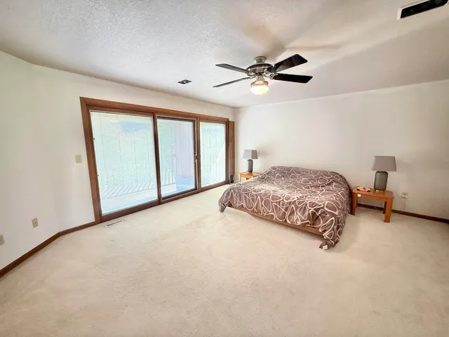 a spacious bedroom with a bed and a window