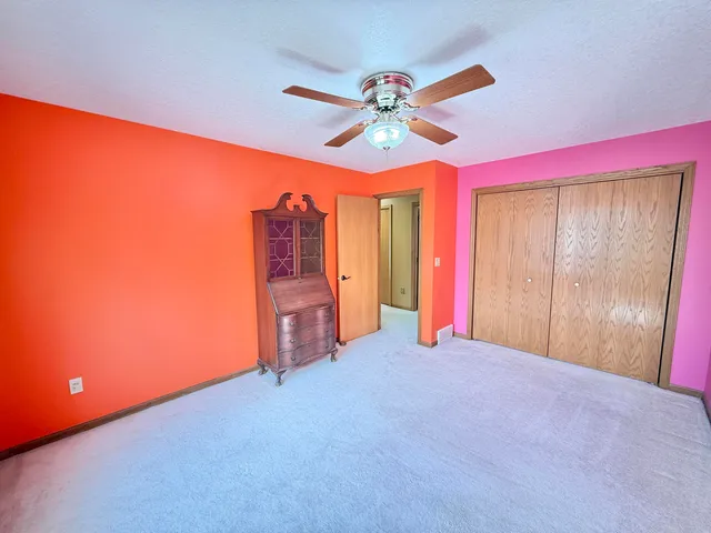 a view of a room with closet and chandelier fan