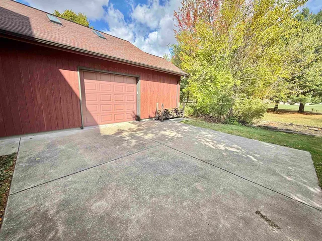 a view of a house with a yard and garage