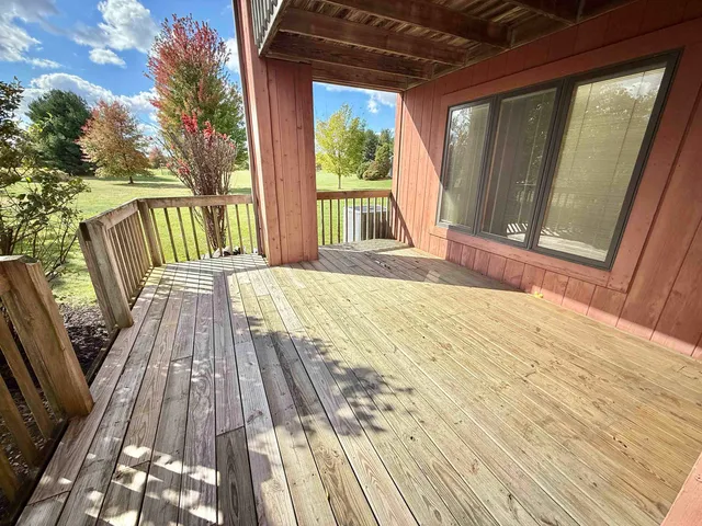 a view of balcony with wooden floor