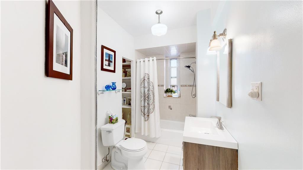 9701 Shore Road, Unit 1N Brooklyn, NY 11209 - Photo 11 of 18 a bathroom with a toilet sink and shower