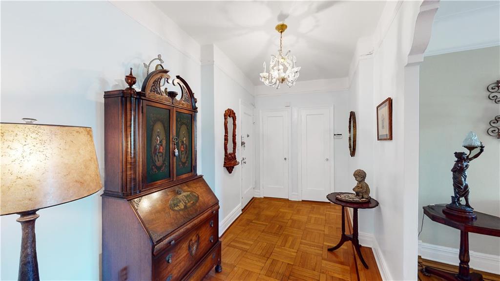 9701 Shore Road, Unit 1N Brooklyn, NY 11209 - Photo 13 of 18 a bedroom with furniture and a chandelier