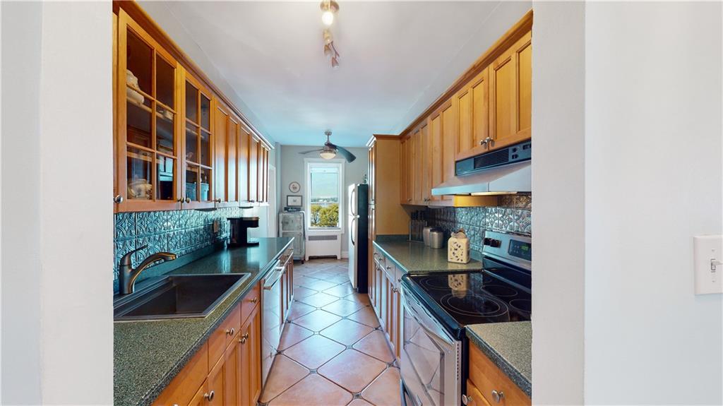 9701 Shore Road, Unit 1N Brooklyn, NY 11209 - Photo 4 of 18 a kitchen with stainless steel appliances granite countertop a stove and a refrigerator