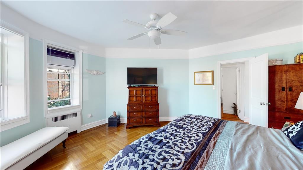 9701 Shore Road, Unit 1N Brooklyn, NY 11209 - Photo 8 of 18 a bedroom with a bed and wooden floor