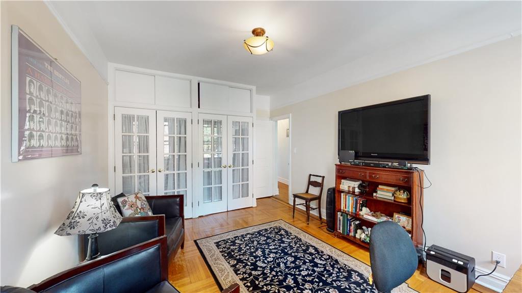 9701 Shore Road, Unit 1N Brooklyn, NY 11209 - Photo 10 of 18 a living room with furniture and a flat screen tv