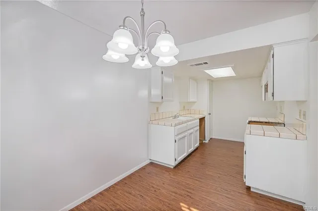 a kitchen with a sink cabinets and wooden floor