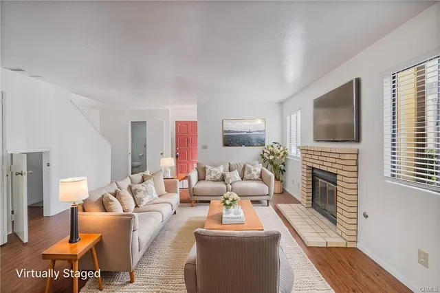 a living room with fireplace furniture and a flat screen tv