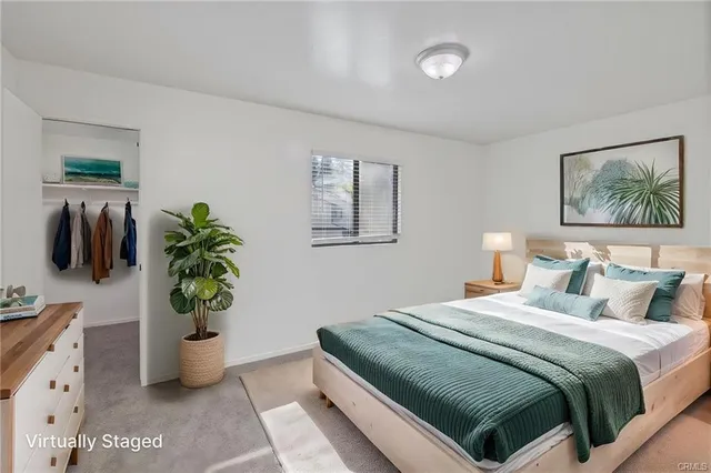a bedroom with a bed and potted plant