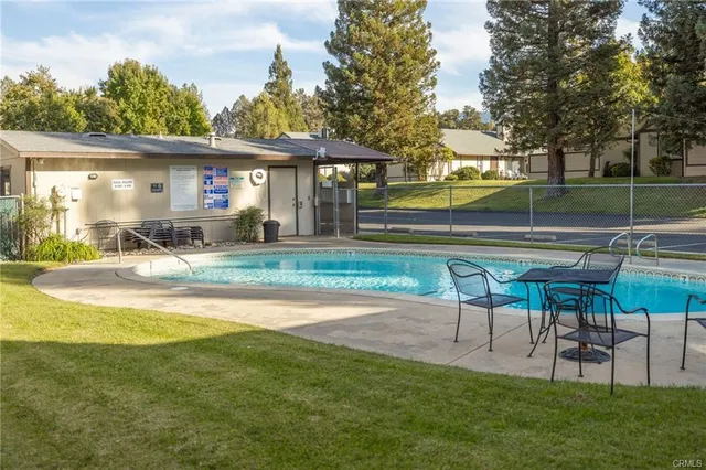 a view of a house with a yard patio and slide