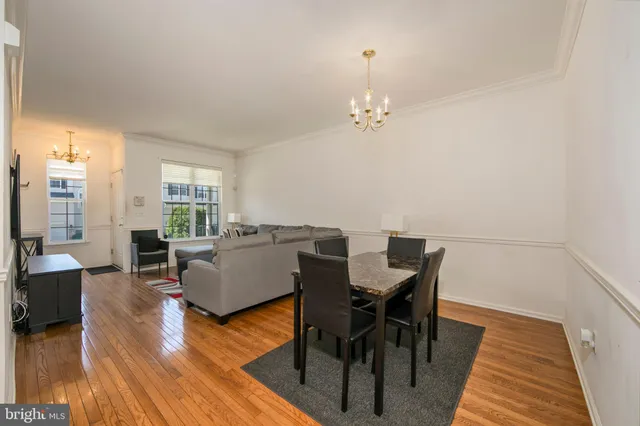 a view of a dining room with furniture wooden floor and chandelier