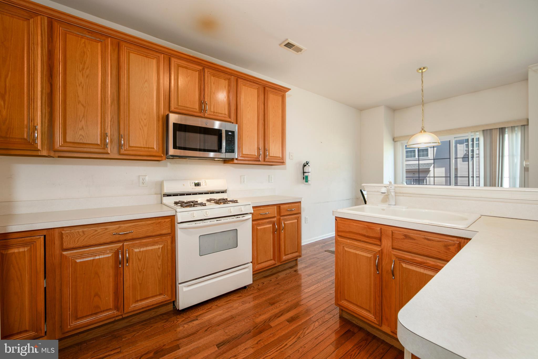342 Huntington Drive Delran, NJ 08075 - Photo 12 of 45 a kitchen with stainless steel appliances granite countertop wooden cabinets a sink and a stove