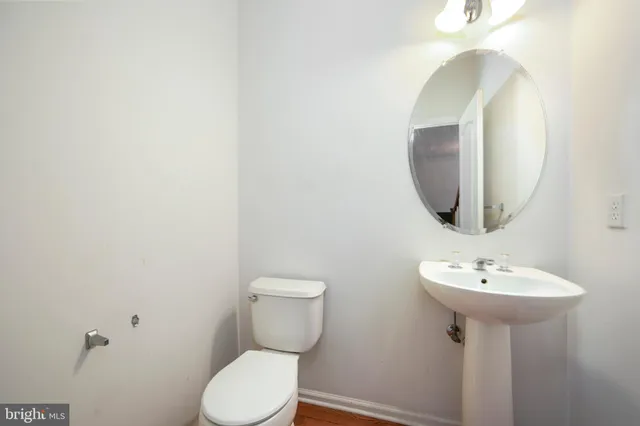 a bathroom with a sink toilet and a mirror