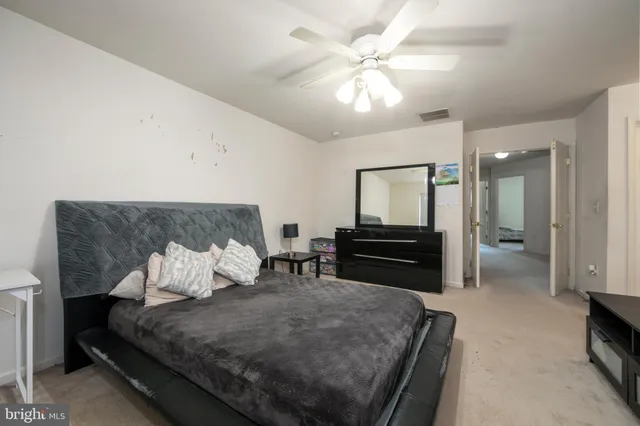 a bedroom with a bed and dresser