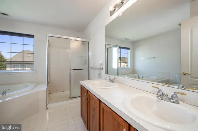 a bathroom with a granite countertop sink mirror and double