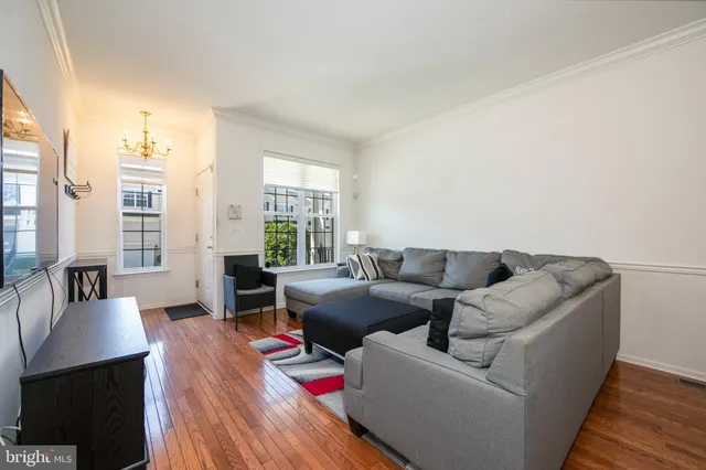 a living room with furniture and large windows