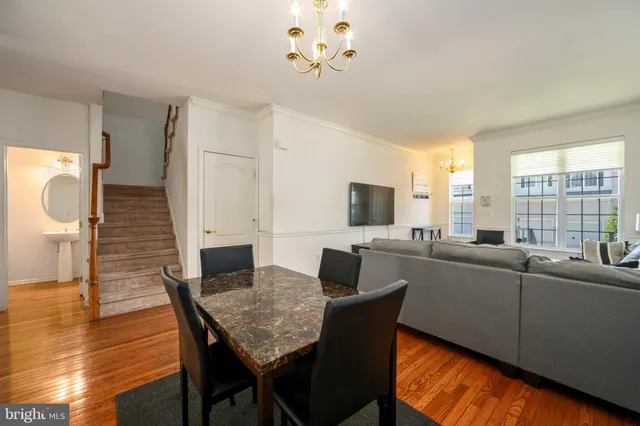 a living room with furniture a large window and a table