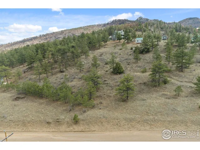 a view of a yard with a wooden fence
