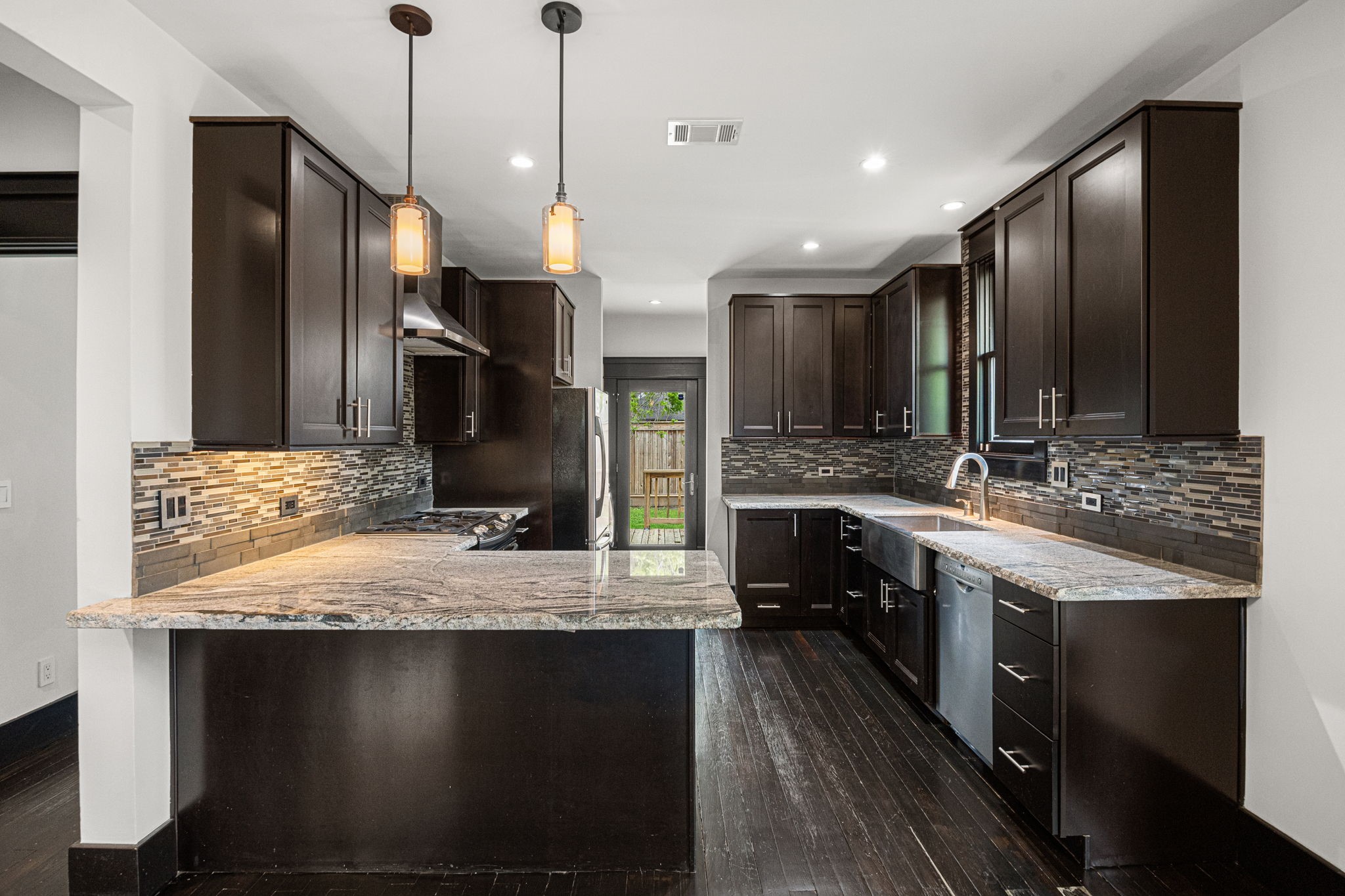 1115 Adele Street Houston, TX 77009 - Photo 4 of 19 Functional kitchen layout with ample cabinetry, prep space, and natural light.