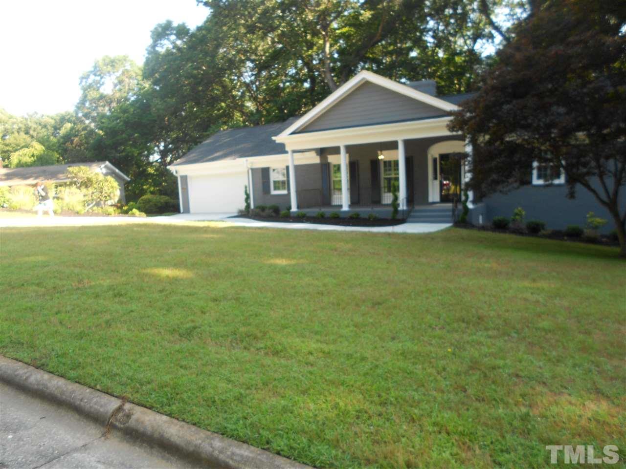 1208 Bancroft Street Raleigh, NC 27612 - Photo 1 of 22 a front view of a house with a garden