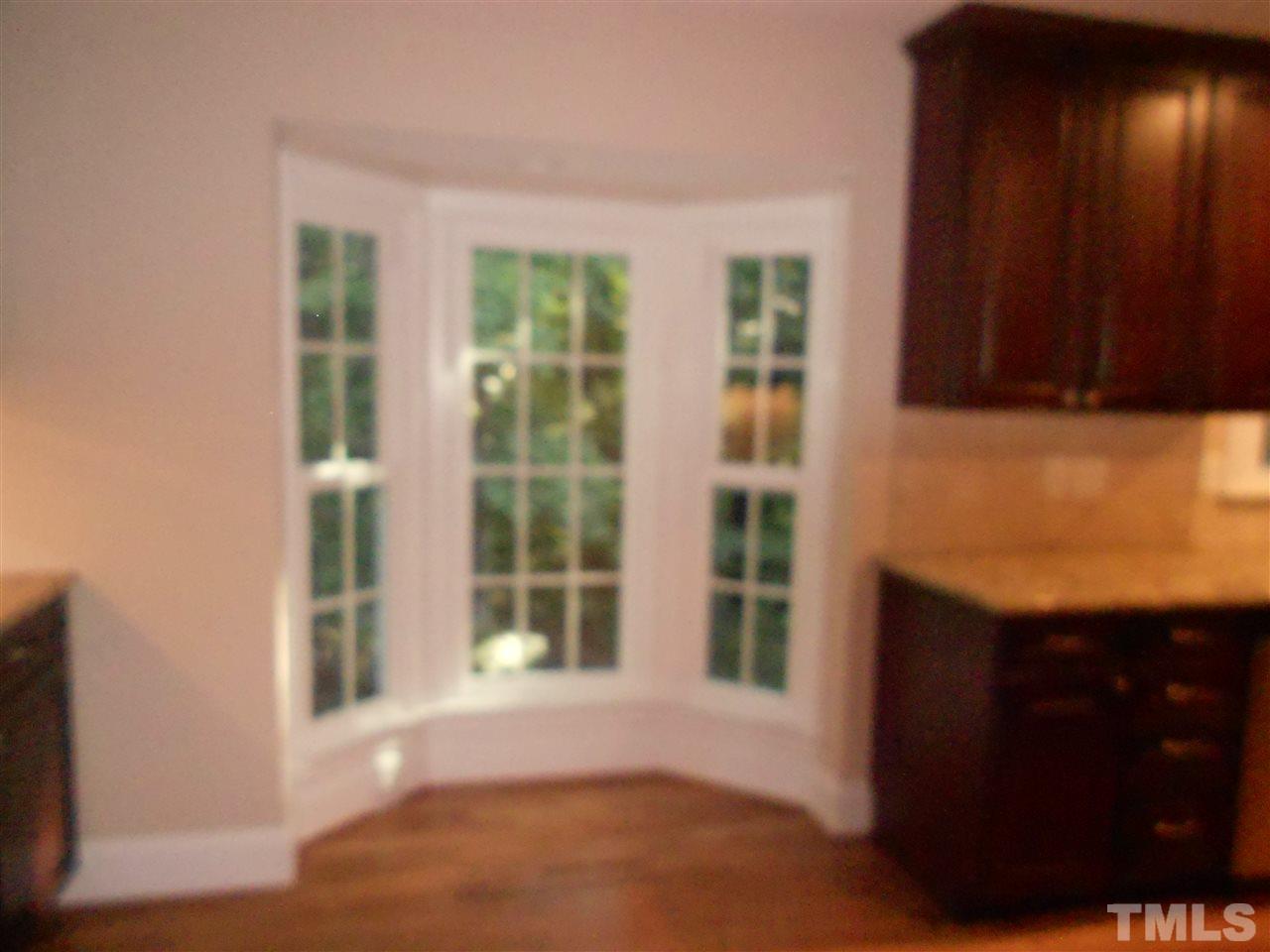 1208 Bancroft Street Raleigh, NC 27612 - Photo 14 of 22 a view of empty room with windows