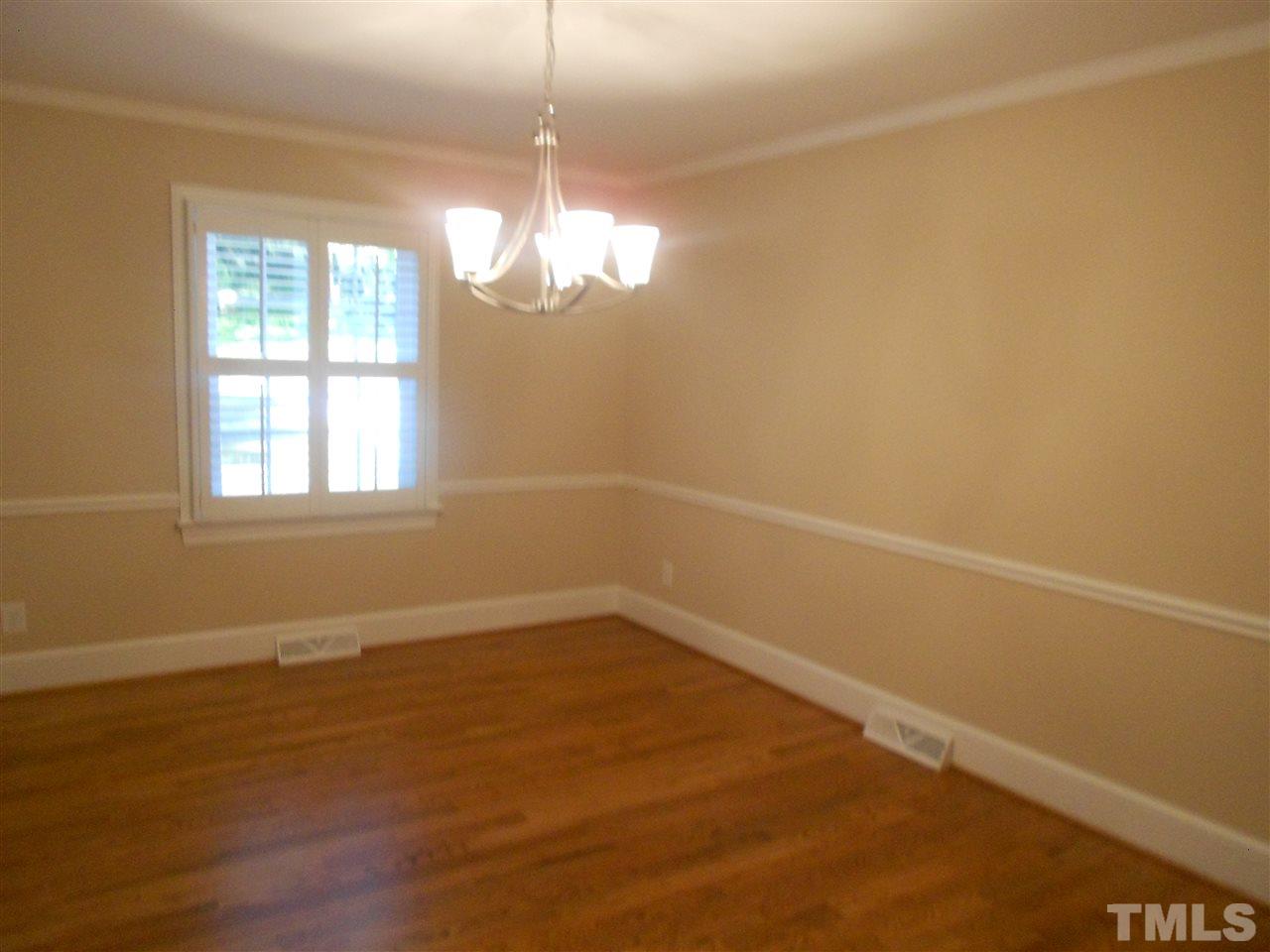 1208 Bancroft Street Raleigh, NC 27612 - Photo 16 of 22 an empty room with wooden floor and windows