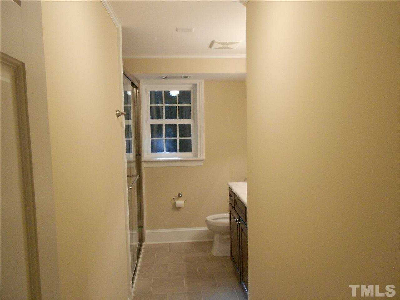 1208 Bancroft Street Raleigh, NC 27612 - Photo 19 of 22 a bathroom with a toilet and a shower