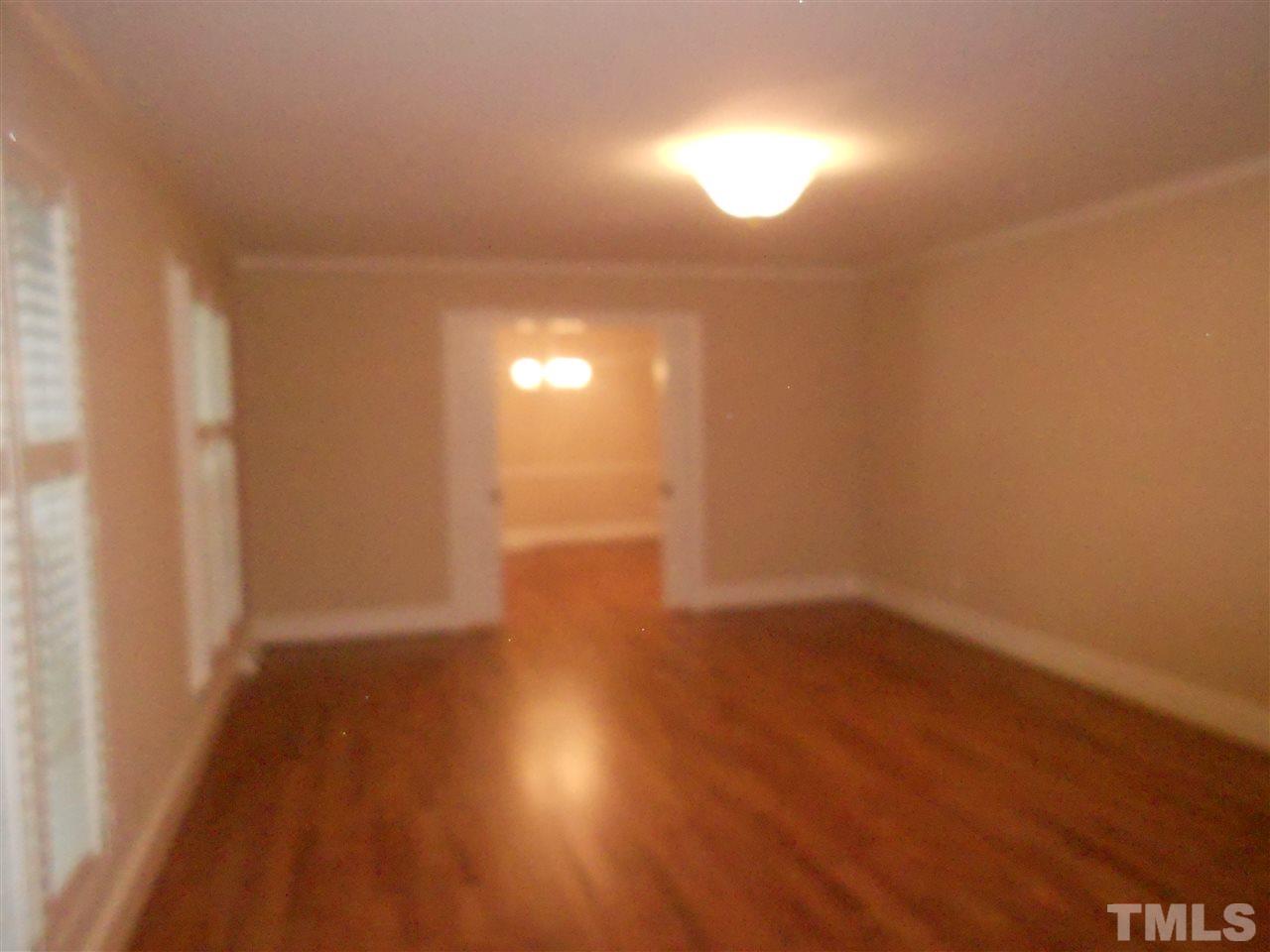 1208 Bancroft Street Raleigh, NC 27612 - Photo 3 of 22 a view of an empty room and wooden floor