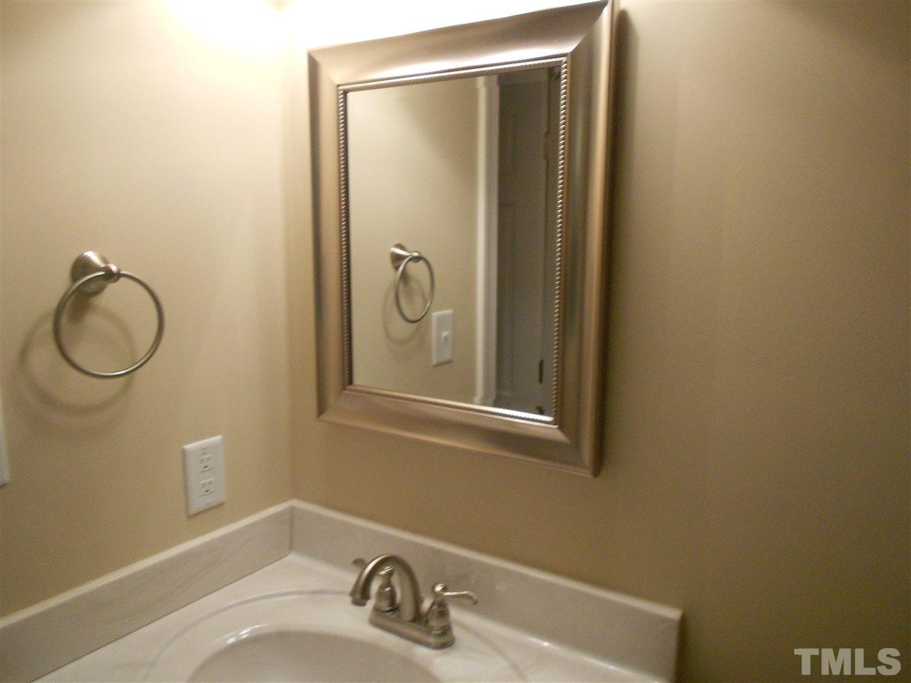 1208 Bancroft Street Raleigh, NC 27612 - Photo 6 of 22 a bathroom with a sink and mirror