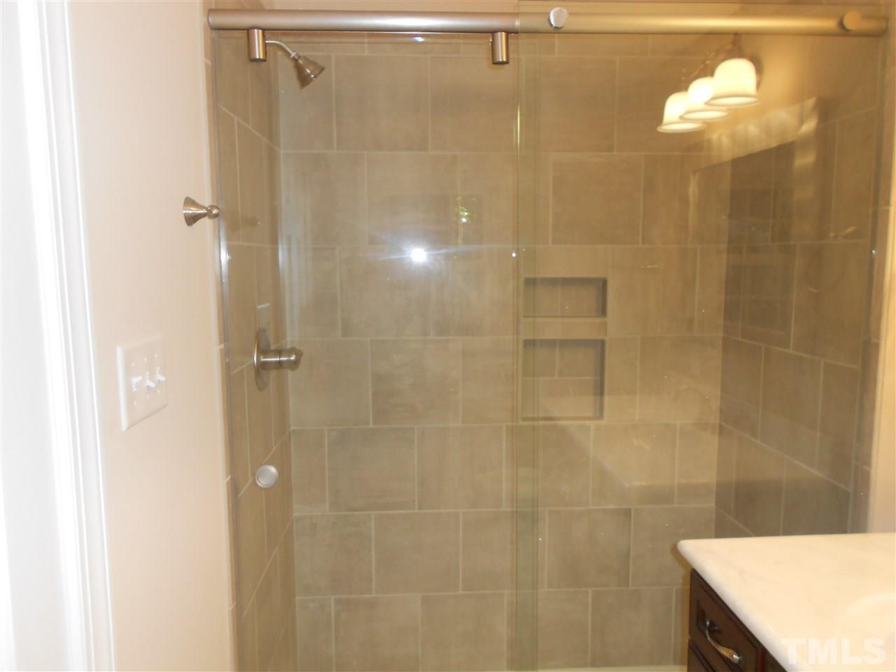 1208 Bancroft Street Raleigh, NC 27612 - Photo 8 of 22 a bathroom with a shower curtain and a sink