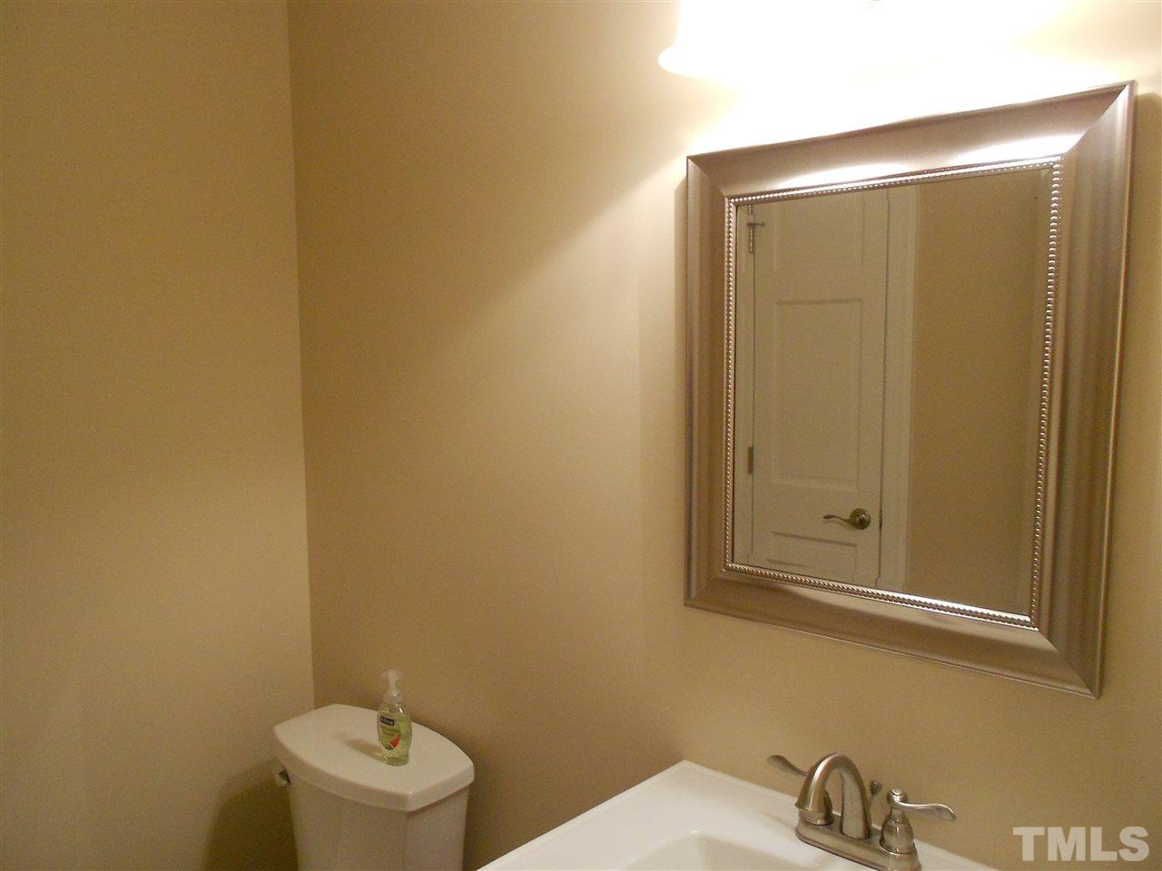 1208 Bancroft Street Raleigh, NC 27612 - Photo 9 of 22 a bathroom with a sink and a mirror