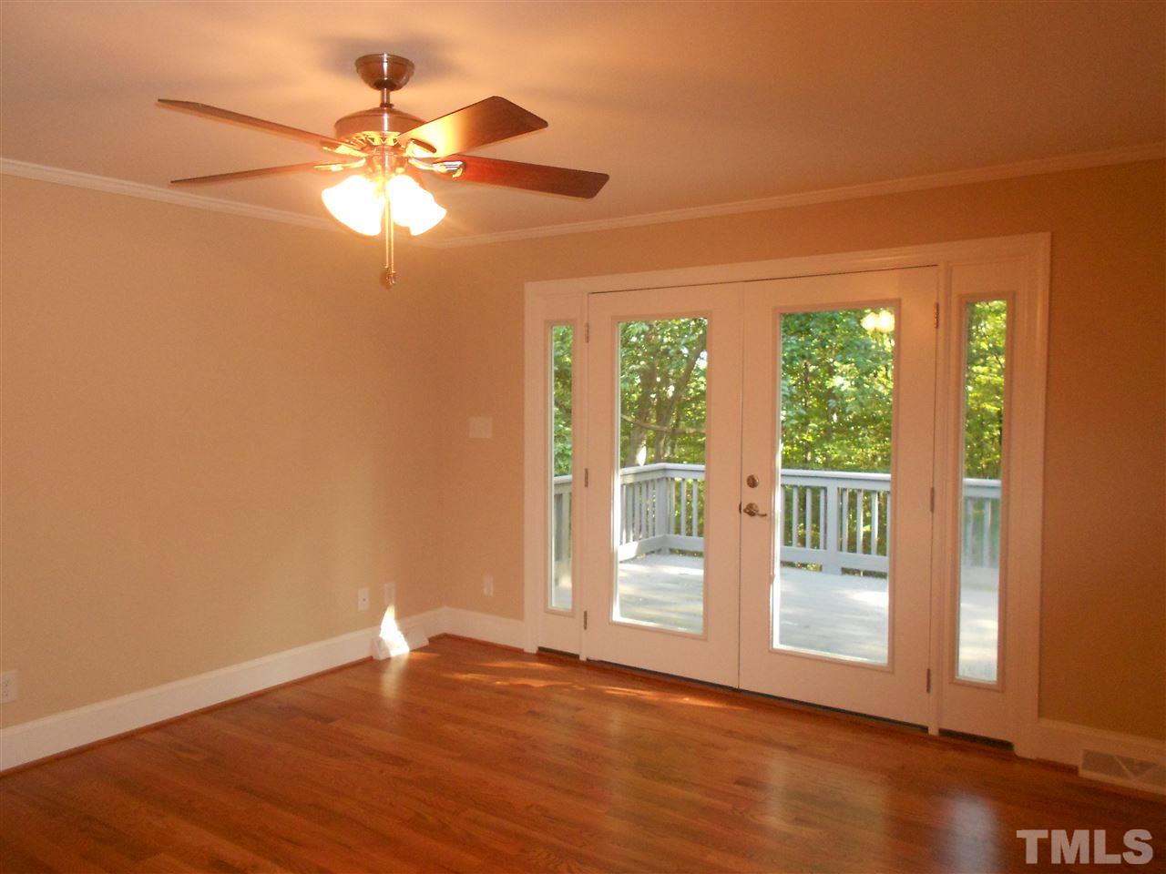 1208 Bancroft Street Raleigh, NC 27612 - Photo 10 of 22 a view of an empty room with wooden floor and a window