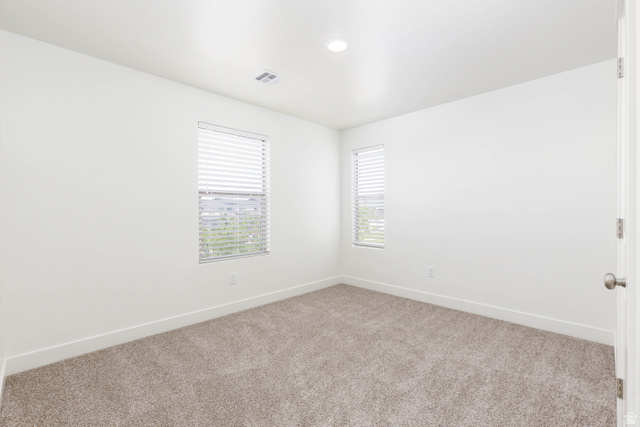3157 Deseret Drive St. George, UT 84790 - Photo 17 of 24 Carpeted room featuring two windows with horizontal blinds, white walls, and recessed ceiling lighting