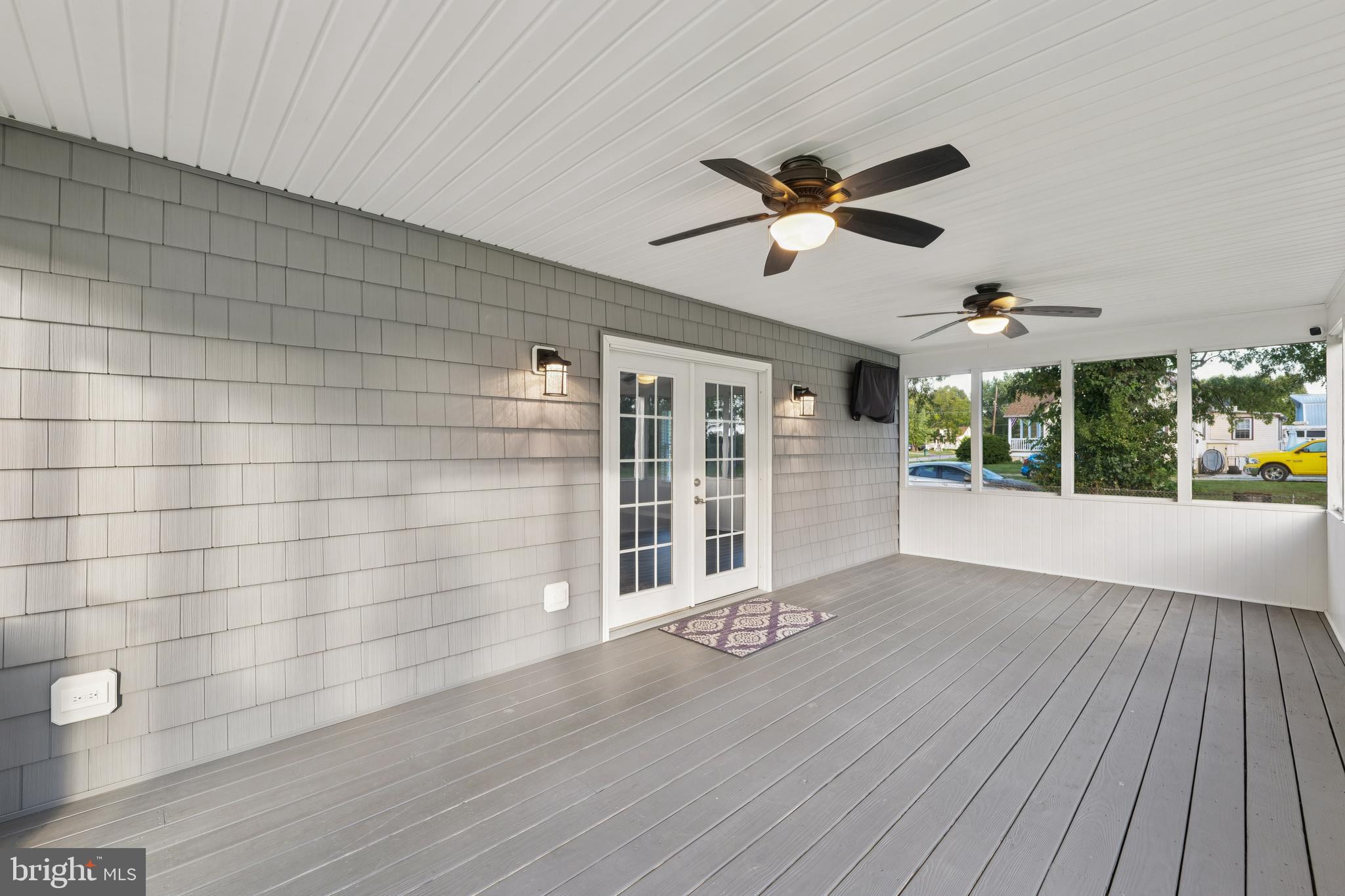 2105 Silver Lane Road Baltimore, MD 21221 - Photo 11 of 55 a view of wooden floor and a chandelier fan in a room