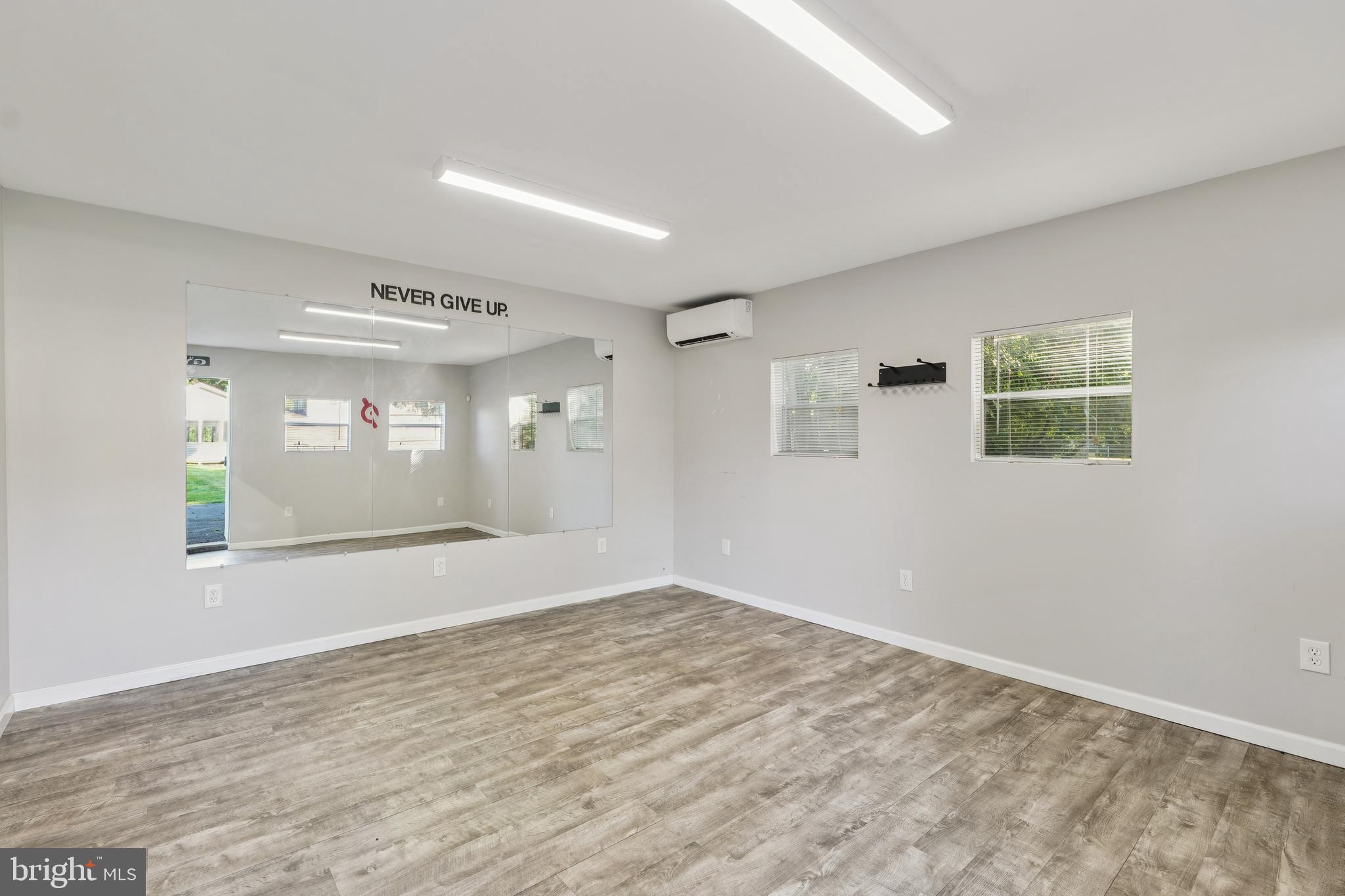 2105 Silver Lane Road Baltimore, MD 21221 - Photo 15 of 55 a view of empty room with wooden floor and fan