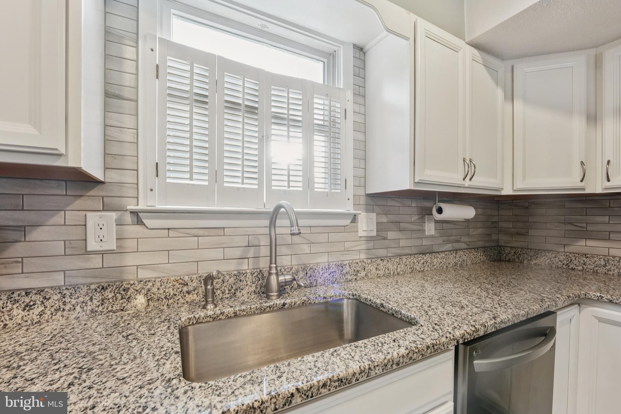 2105 Silver Lane Road Baltimore, MD 21221 - Photo 21 of 55 a kitchen with granite countertop a sink and a window