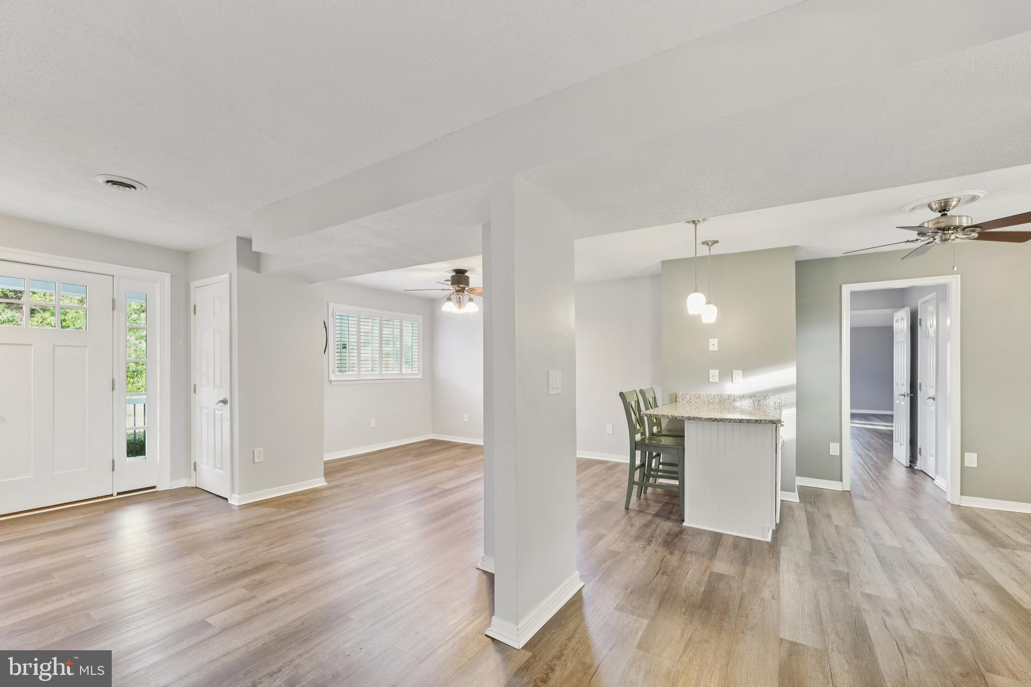 2105 Silver Lane Road Baltimore, MD 21221 - Photo 22 of 55 a view of empty room with wooden floor and fan