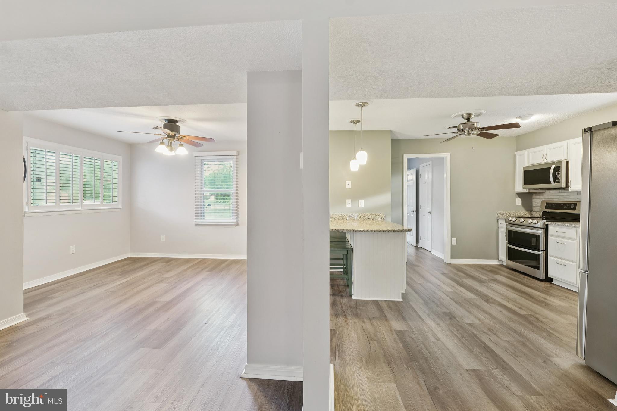 2105 Silver Lane Road Baltimore, MD 21221 - Photo 23 of 55 wooden floor in an empty room with a window