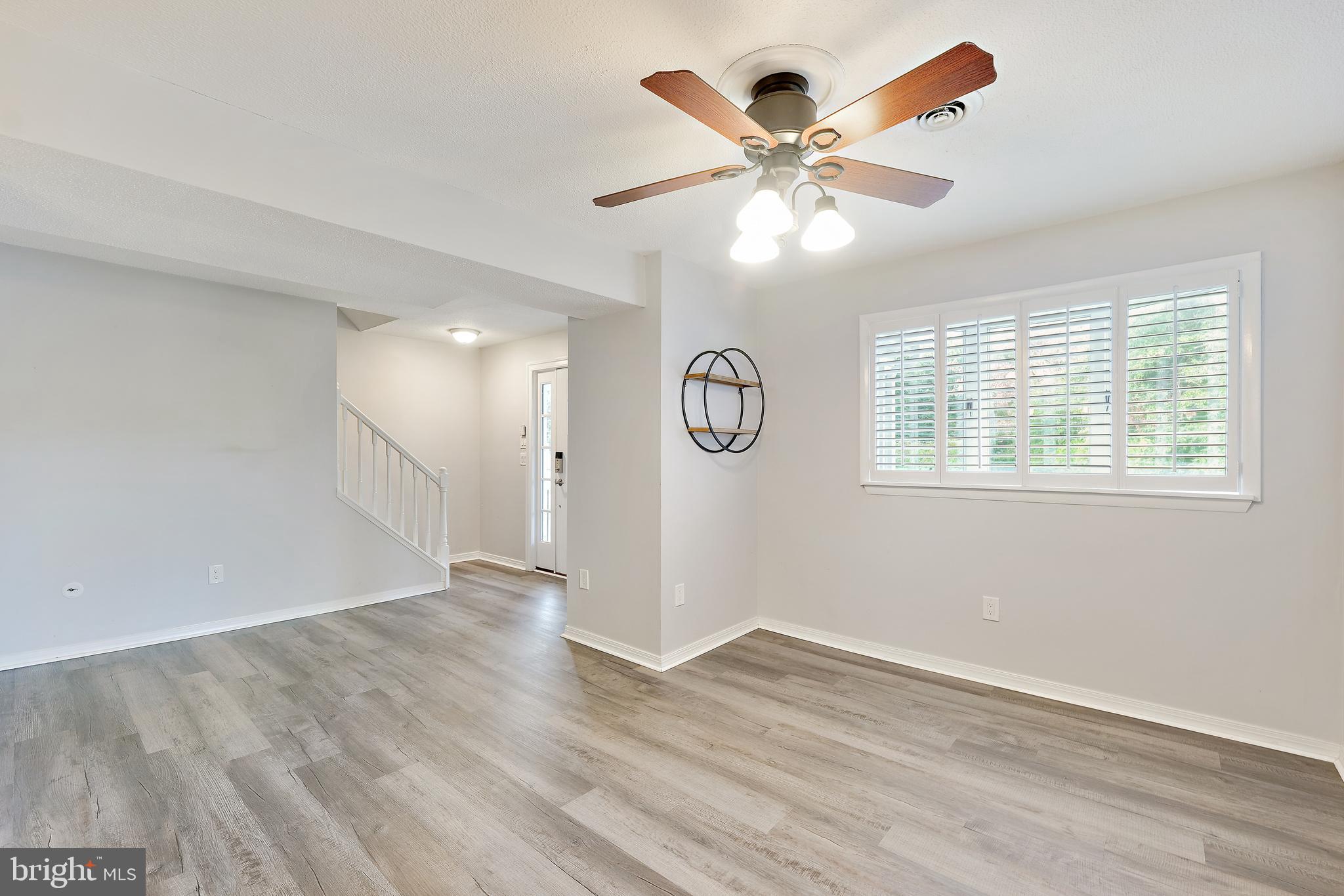 2105 Silver Lane Road Baltimore, MD 21221 - Photo 25 of 55 a view of an empty room with wooden floor and a window