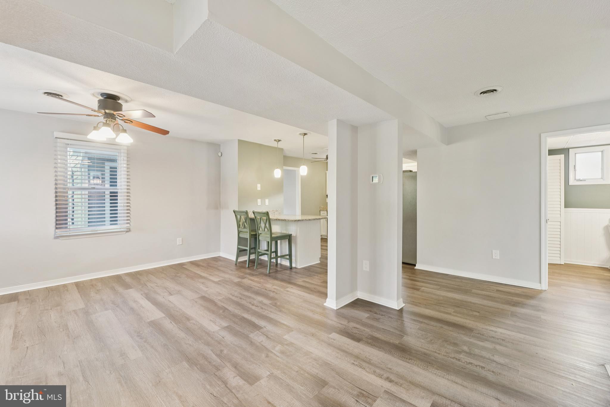 2105 Silver Lane Road Baltimore, MD 21221 - Photo 27 of 55 a view of an empty room with wooden floor and a window