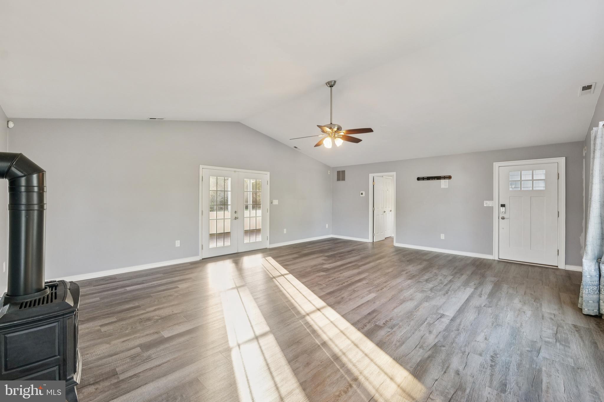 2105 Silver Lane Road Baltimore, MD 21221 - Photo 29 of 55 a view of an empty room with window and wooden floor