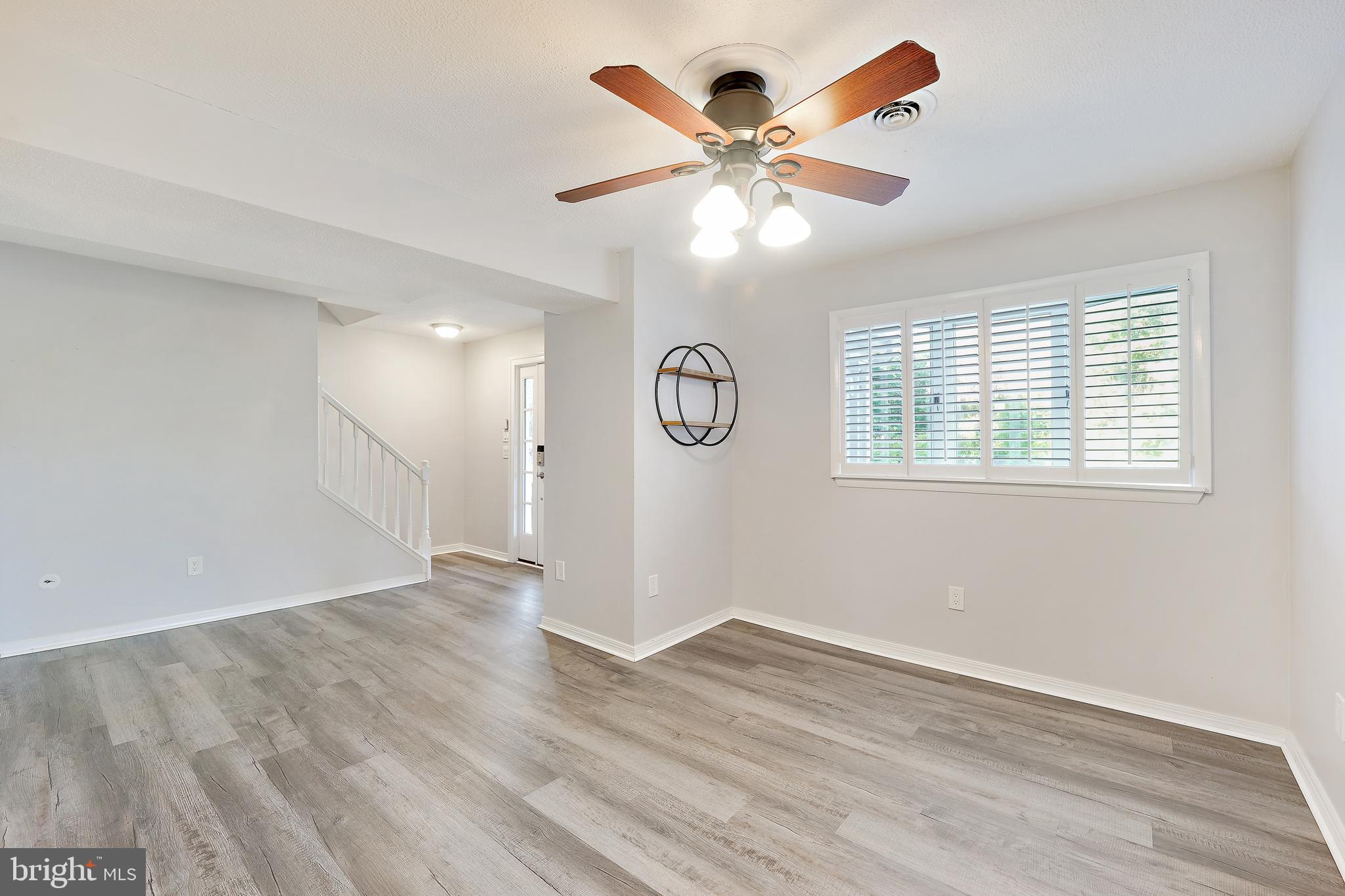 2105 Silver Lane Road Baltimore, MD 21221 - Photo 32 of 55 wooden floor in an empty room with a window