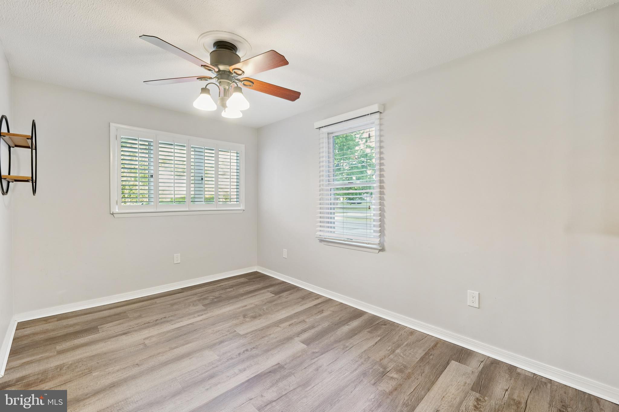 2105 Silver Lane Road Baltimore, MD 21221 - Photo 33 of 55 a view of an empty room with wooden floor and a window